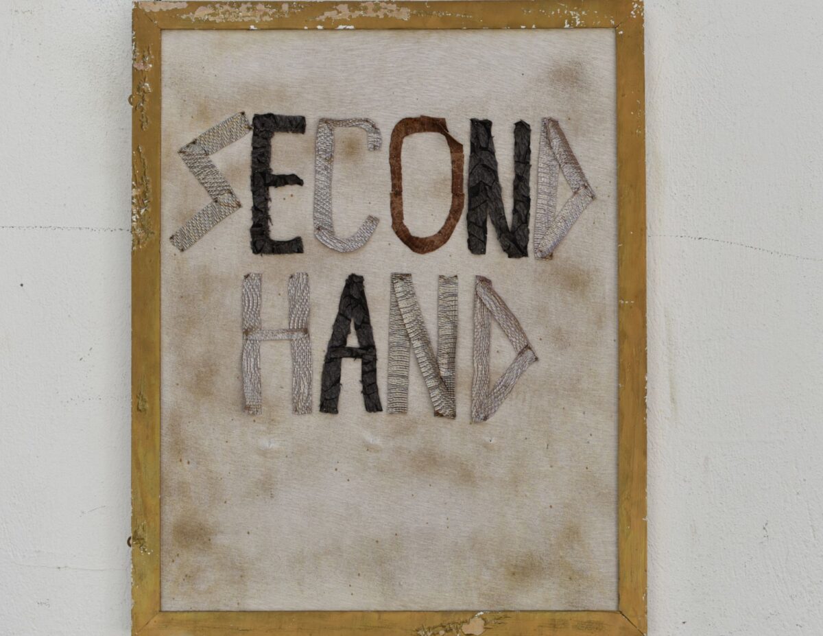 Wall hanging with "Second hand" embroidered on it - frugal tips from the Great Depression.