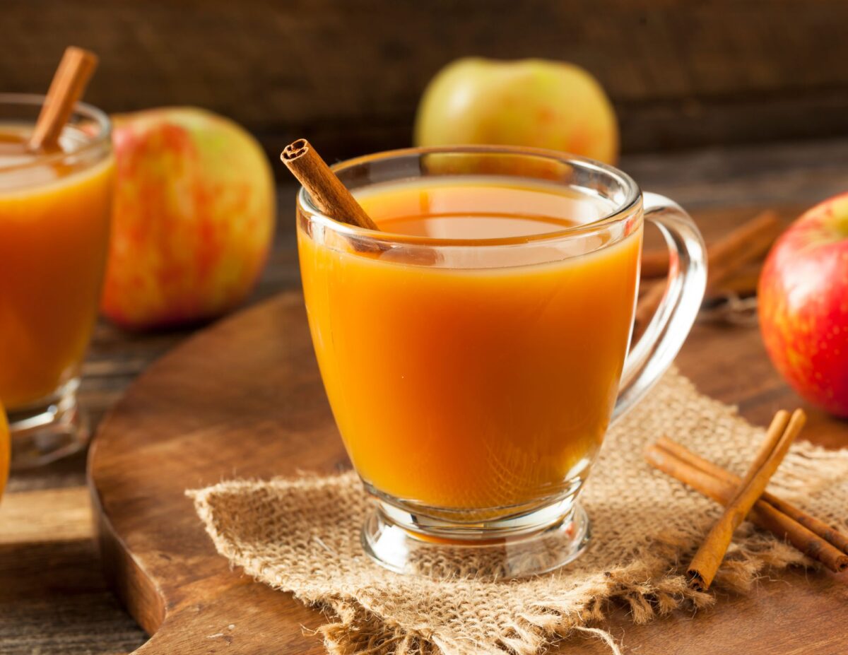 A cup of apple cider with a cinnamon stick in it - what to do with excess apples.