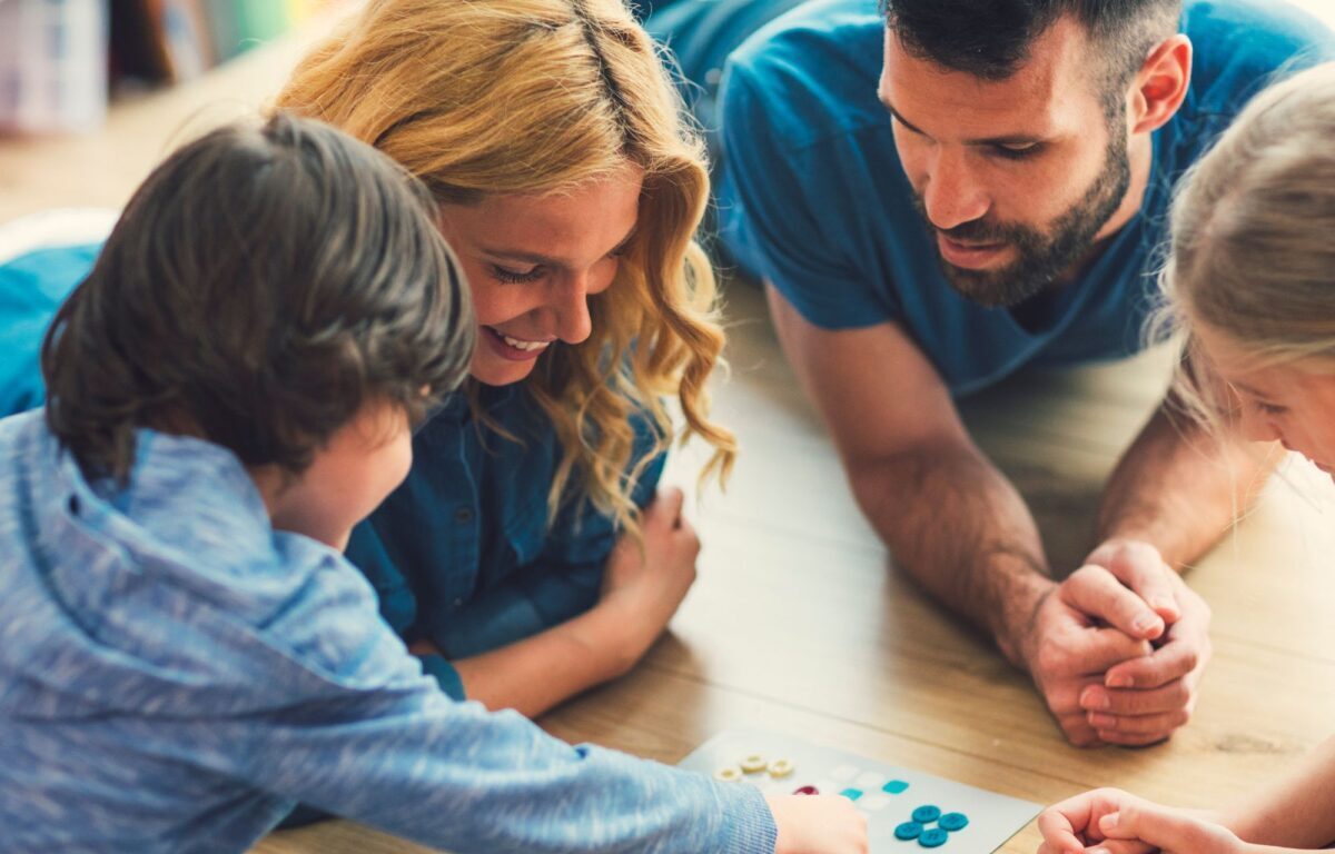 picture of happy family playing a game to represent Family category
