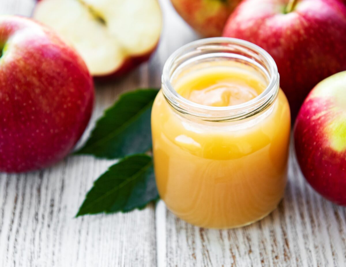 Apple sauce in a jar with apples around it - frugal baking tips.