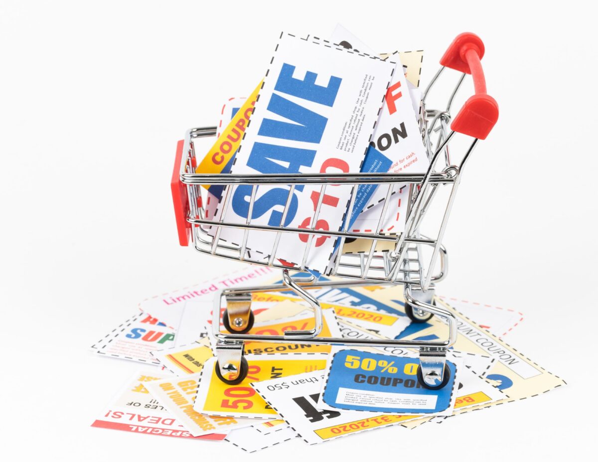 A shopping cart is filled with coupons - frugal baking tips.