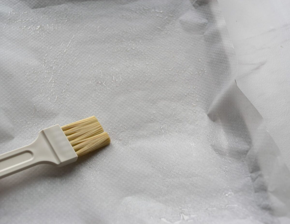 Parchment paper with a pastry brush - frugal baking tips.