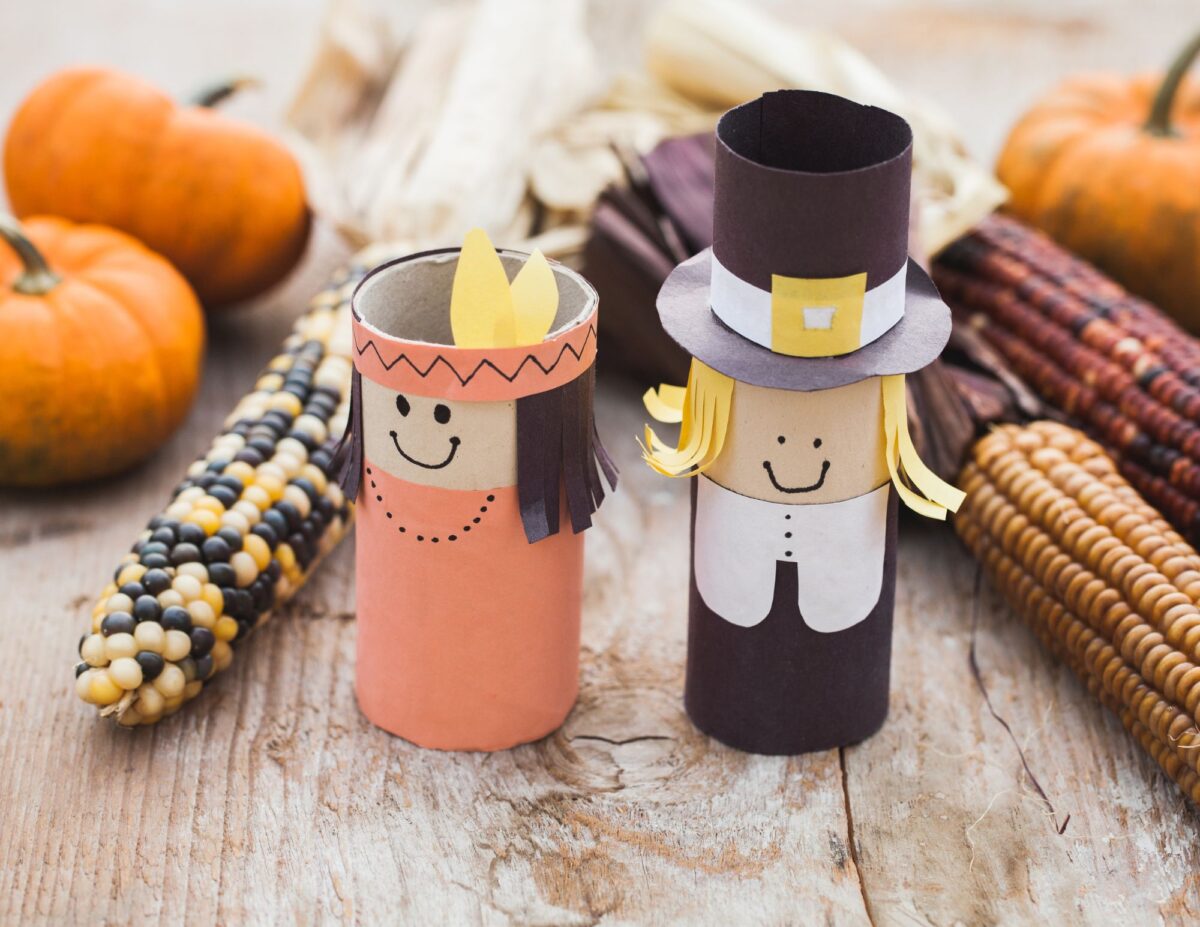 Paper pilgrim decorations with colorful ears of corn and pumpkins - frugal living tips for families.