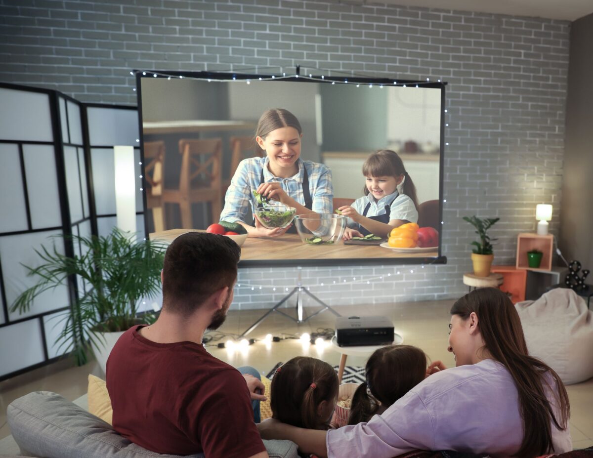 A family is watching their TV - frugal living tips for families.