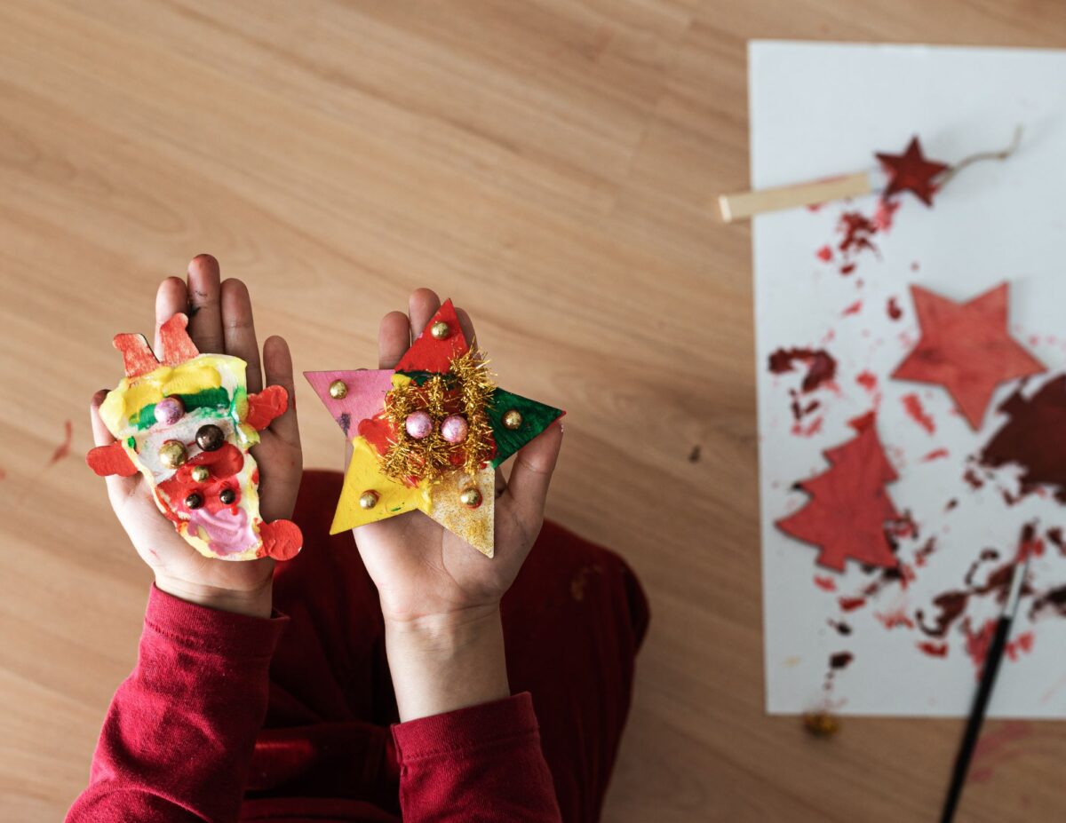 a child is making Christmas decorations - inexpensive Christmas gifts for teachers.