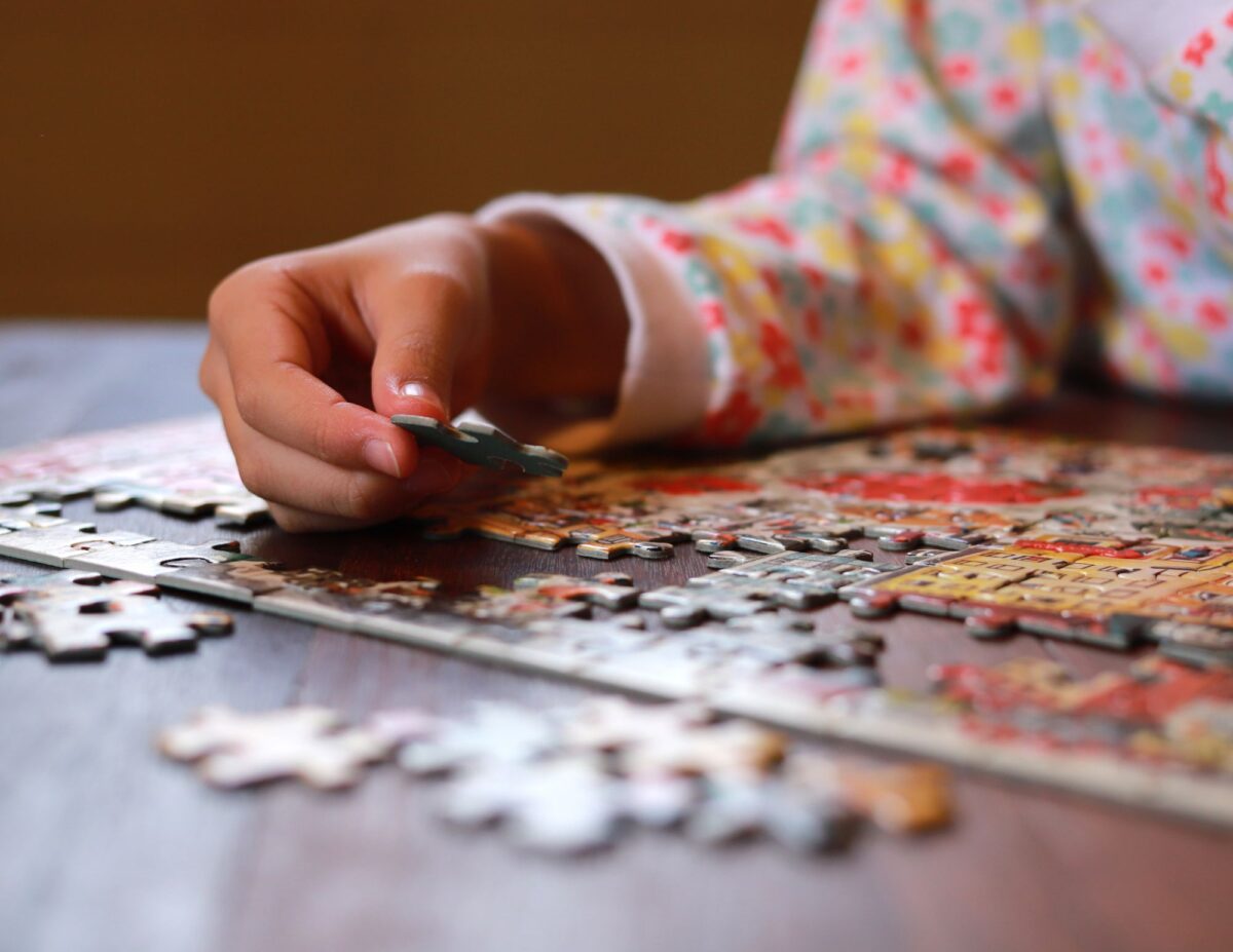someone is doing a jigsaw puzzle - cheap winter indoor activities