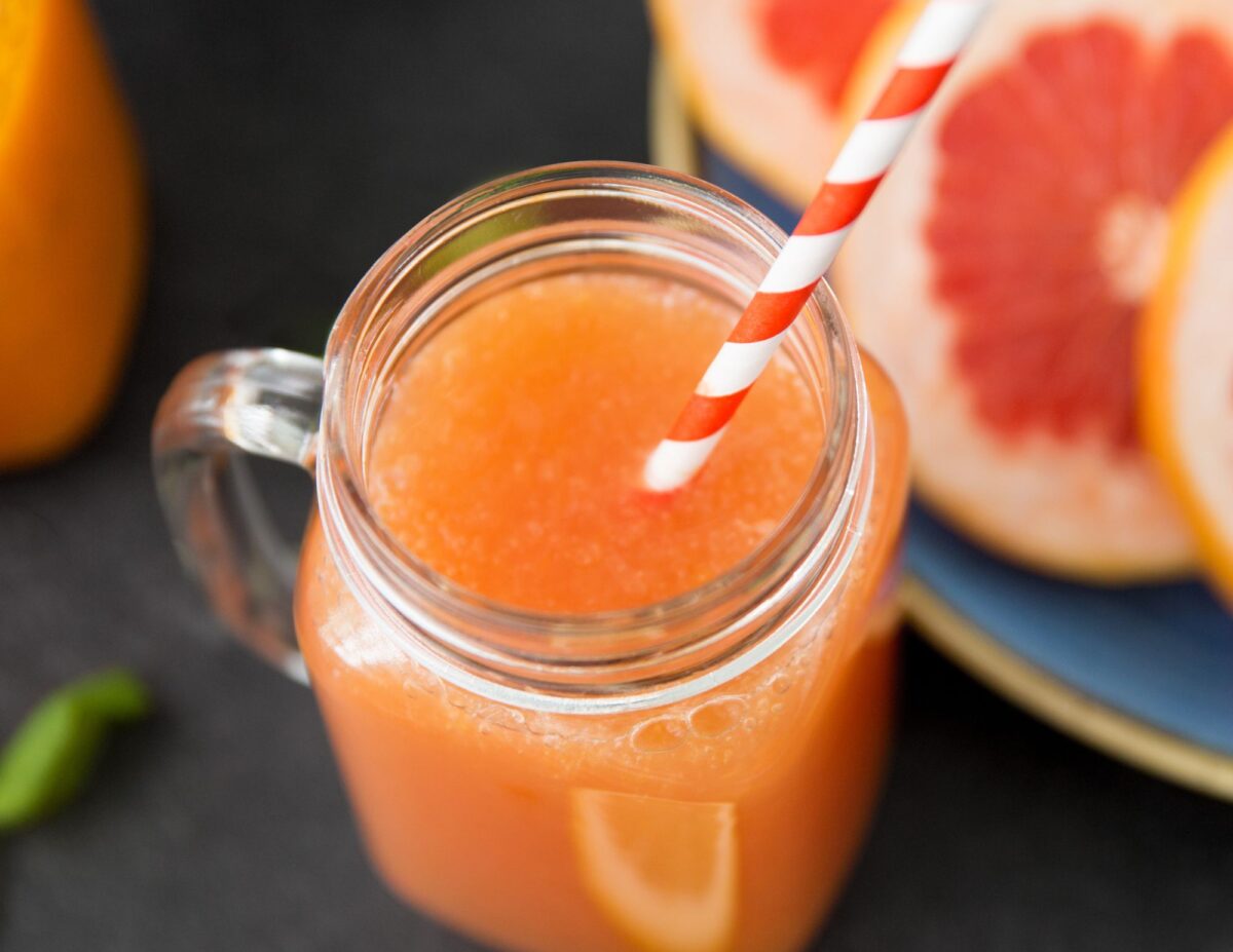 mason jar with juice and fancy straw - cheap baby shower food ideas.
