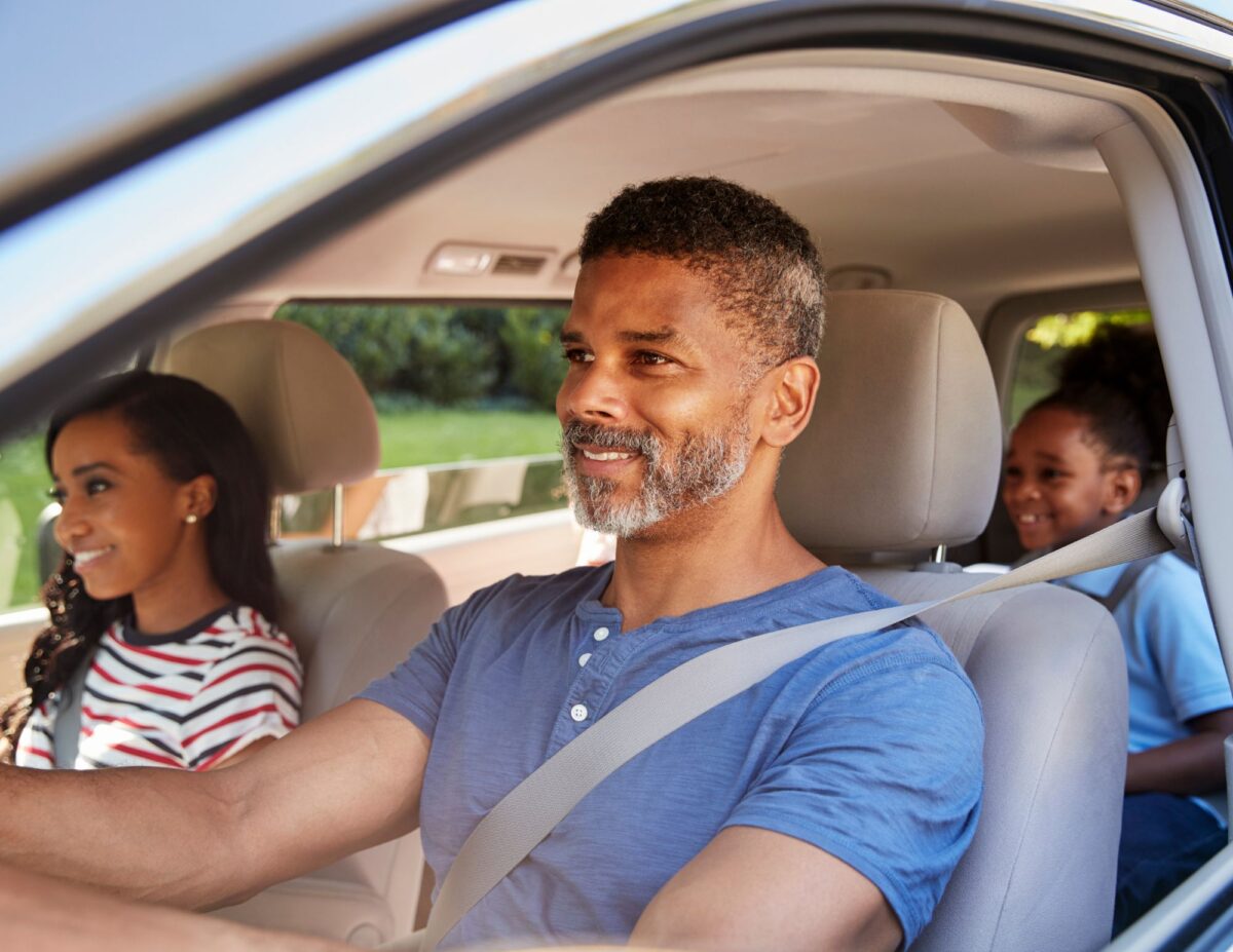 A family is riding in a car - frugal family travel tips.