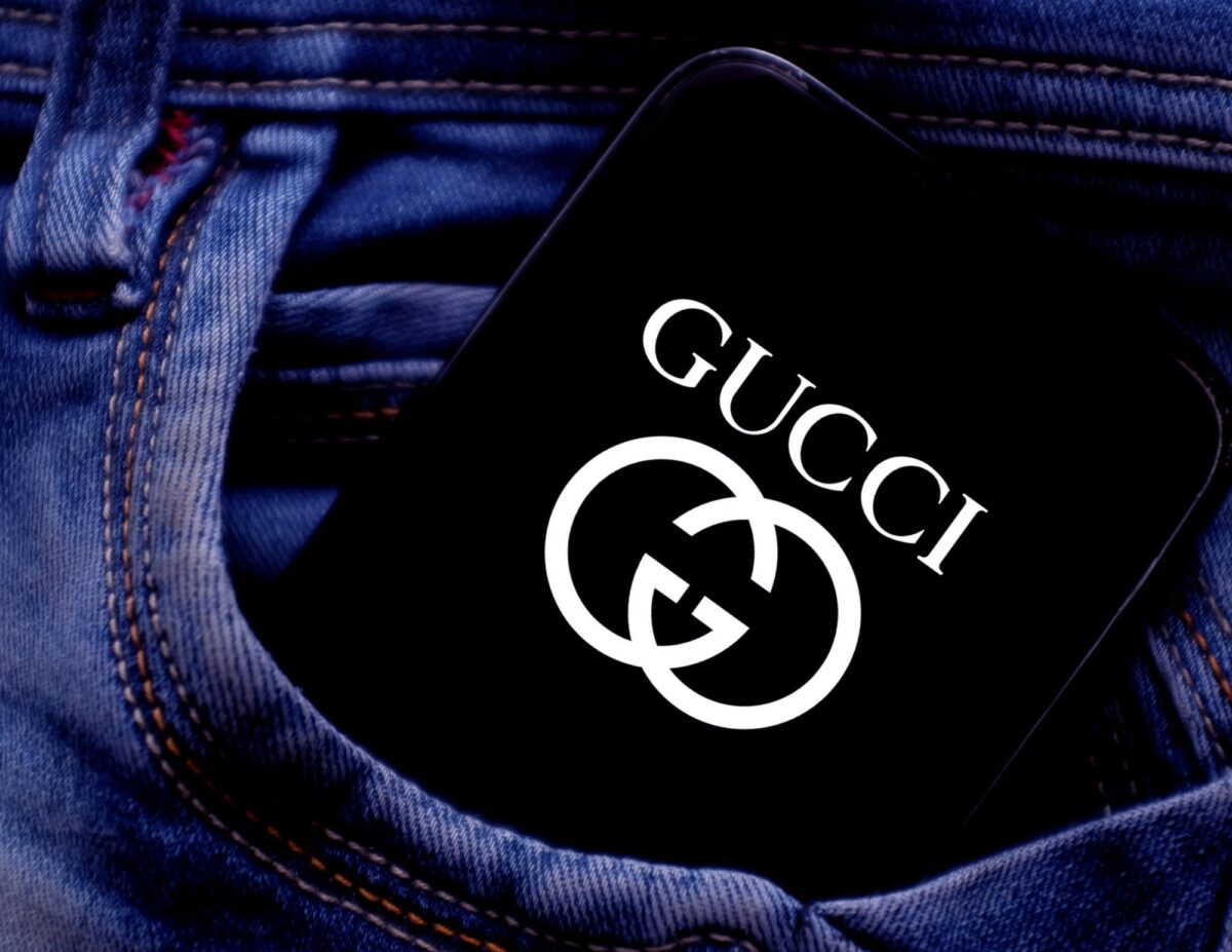 a pants pocket with a phone that displays the Gucci Logo - most valuable thrift sotre finds