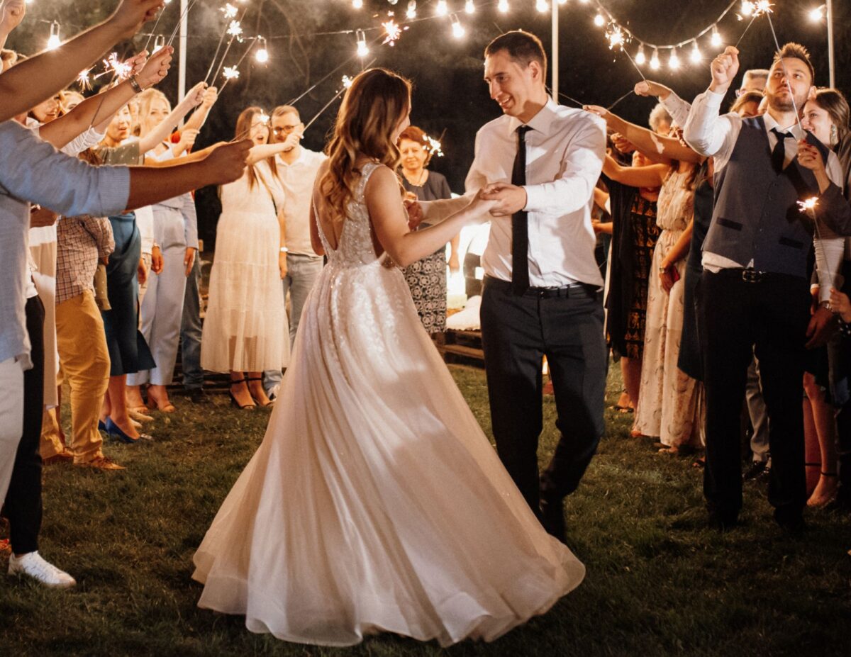 bride and groom dancing under a tent - outdoor wedding ideas on a budget