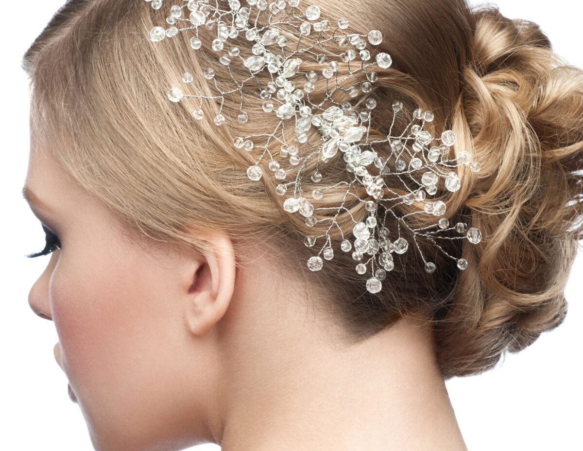 someone with an elaborate hair accessory - outdoor wedding ideas on a budget