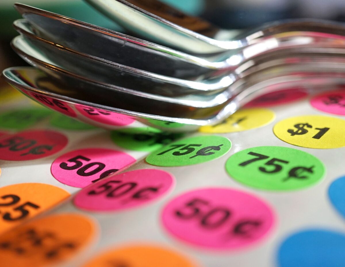 colorful price stickers with a stack of spoons - how to have a successful yard sale