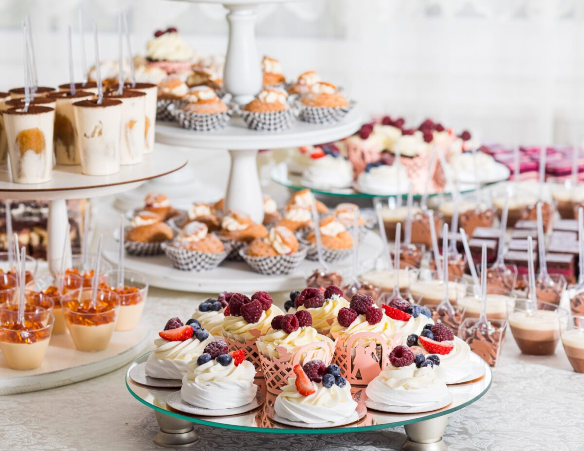 lots of different desserts set up on a table - outdoor wedding ideas on a budget