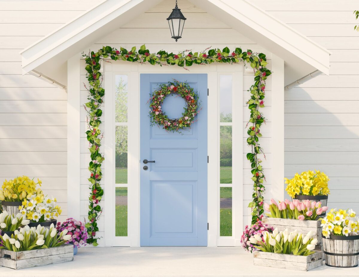 a front entrance to a house decorated with lots of plants and colorful flowers - front door decorations for spring