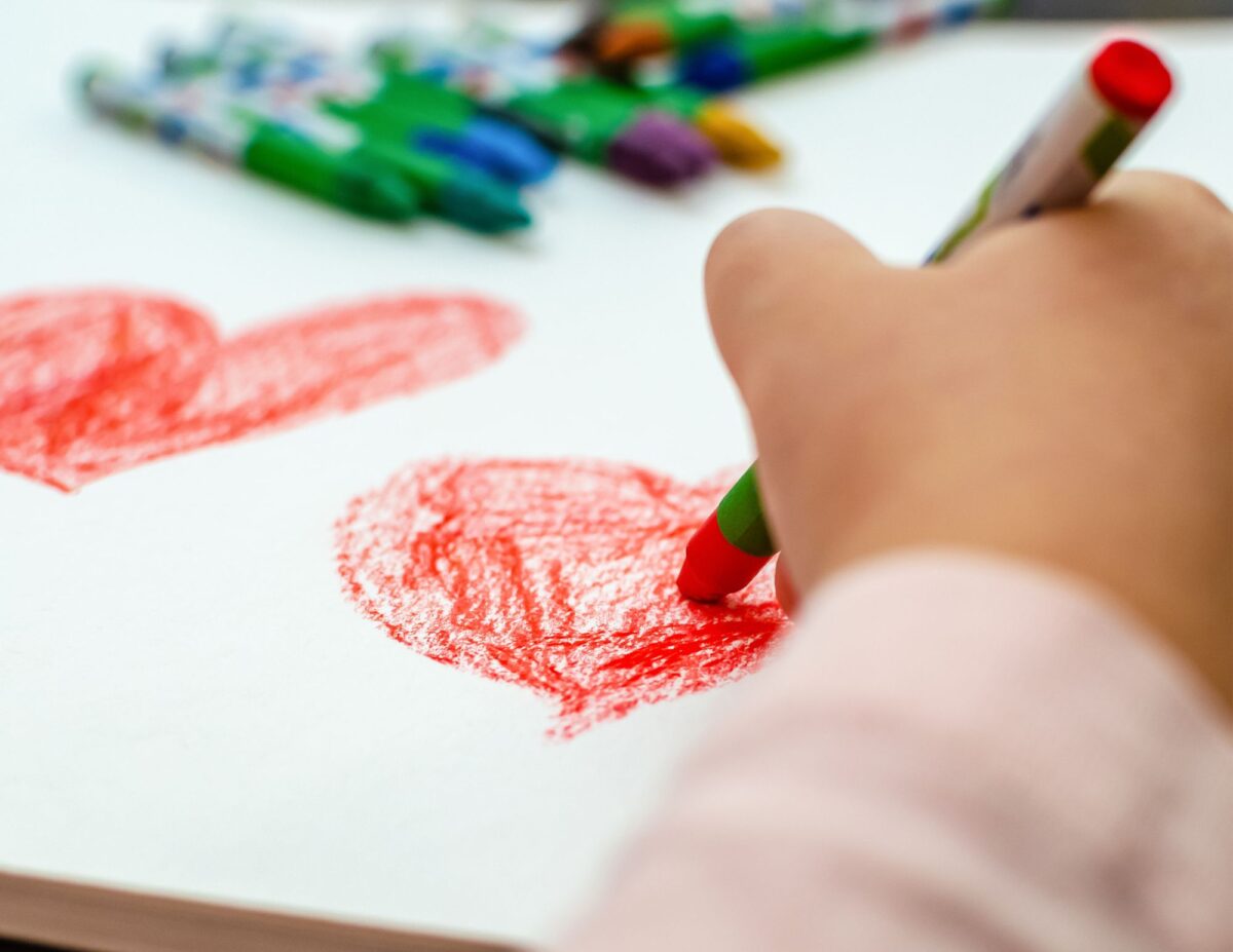 someone coloring in a heart - printable valentine's day crafts for preshoolers
