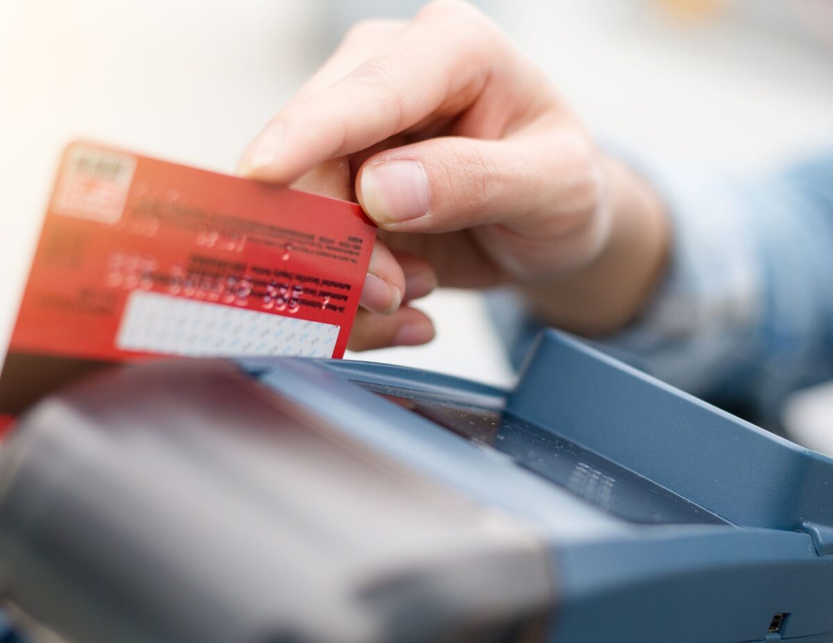 someone using a debit card - 52-week money savings challenge