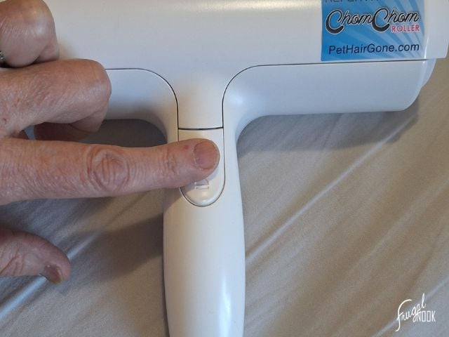 pressing the release button to the lint chamber on the ChomChom Roller.