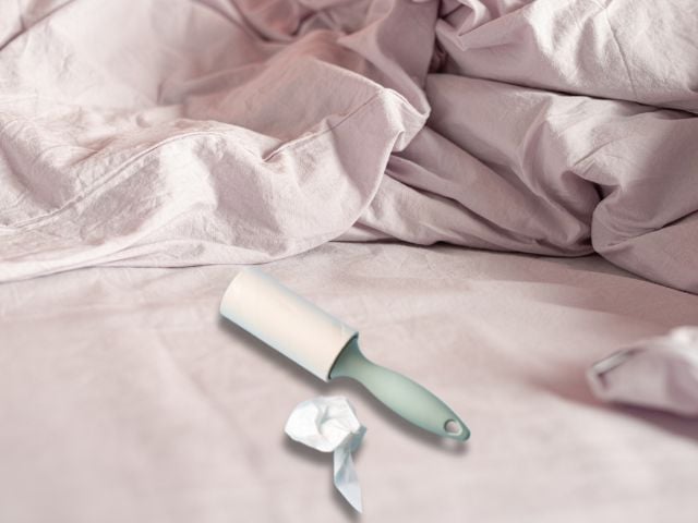 a sticky lint roller and crumbled up sticky sheet on a bed - ChomChom Lint and Pet Hair Remover
