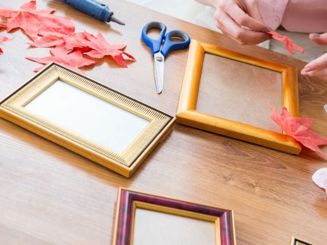 some one has frames on a table with scissors - baby shower favors